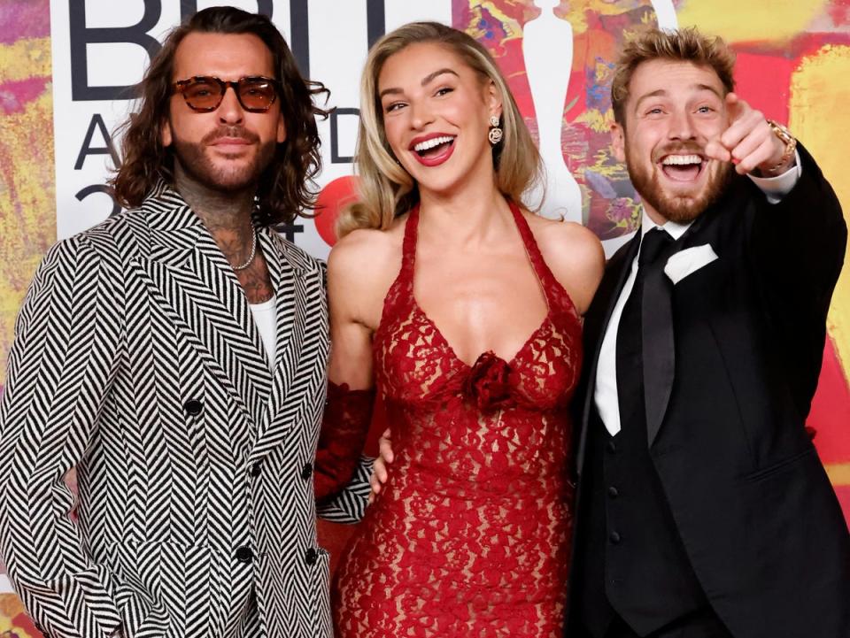 Left to right: Pete Wicks, Zara McDermott and Sam Thompson pose on the red carpet (AFP)