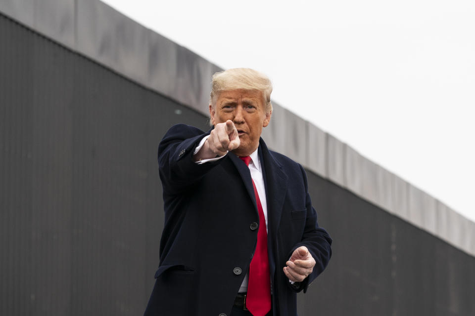 President Donald Trump points to a member of the audience after speaking near a section of the U.S.-Mexico border wall, Tuesday, Jan. 12, 2021, in Alamo, Texas. (AP Photo/Alex Brandon)