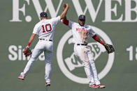 Boston Red Sox outfielders Hunter Renfroe (10) and Franchy Cordero, right, celebrate their 11-4 victory over the Chicago White Sox after a baseball game at Fenway Park, Monday, April 19, 2021, in Boston. (AP Photo/Elise Amendola)