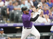 Colorado Rockies' Kris Bryant singles off Los Angeles Dodgers starting pitcher Tyler Anderson during the third inning of a baseball game Monday, June 27, 2022, in Denver. (AP Photo/David Zalubowski)