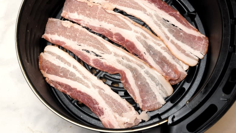 raw bacon cooking