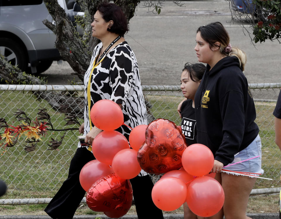 Families of victims of the White Island eruption arrive a the Whakatane wharf following a blessing at sea ahead of the recovery operation off the coast of Whakatane New Zealand, Friday, Dec. 13, 2019. A team of eight New Zealand military specialists landed on White Island early Friday to retrieve the bodies of victims after the Dec. 9 eruption. (AP Photo/Mark Baker)