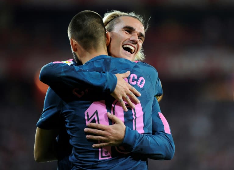 Atletico Madrid's Yannick Ferreira Carrasco (L) is congratulated by teammate Antoine Griezmann after scoring his team's second goal during their match against Athletic Club Bilbao in Bilbao on September 20, 2017