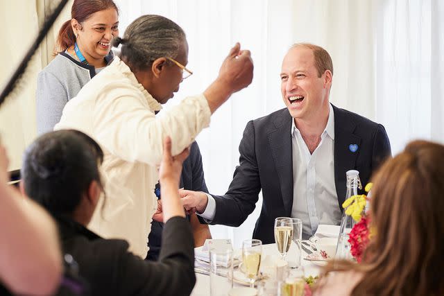 <p>Tom Dymond/REX Shutterstock</p> Prince William enjoying a laugh with a guest at the NHS Big Tea party