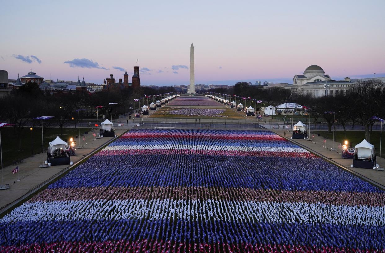 <p>The ‘Field of Flags’ and the Washington Monument are seen on the National Mall in front of the Capitol building</p> (AFP via Getty)