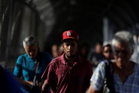 People walk on the International border bridge Paso del Norte to cross from Ciudad Juarez into El Paso, Texas, U.S. in this picture taken from Ciudad Juarez