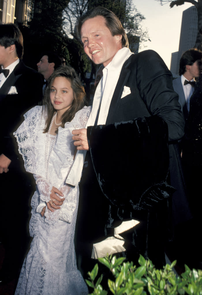 Angelina Jolie first graced the Academy Awards red carpet back in 1986 when she accompanied her father Jon Voight, who was a Best Actor nominee that year. At just nine-years-old, Jolie probably had little idea she would later win an Oscar, endure a seven-year rift with her father, stir up scandal with her brother and rule the arrivals as one half of Hollywood's most famous couple.