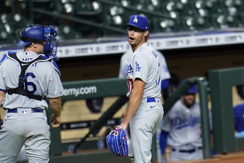 Los Angeles Dodgers relief pitcher Joe Kelly (17) talks toward Houston Astros' Carlos Correa.