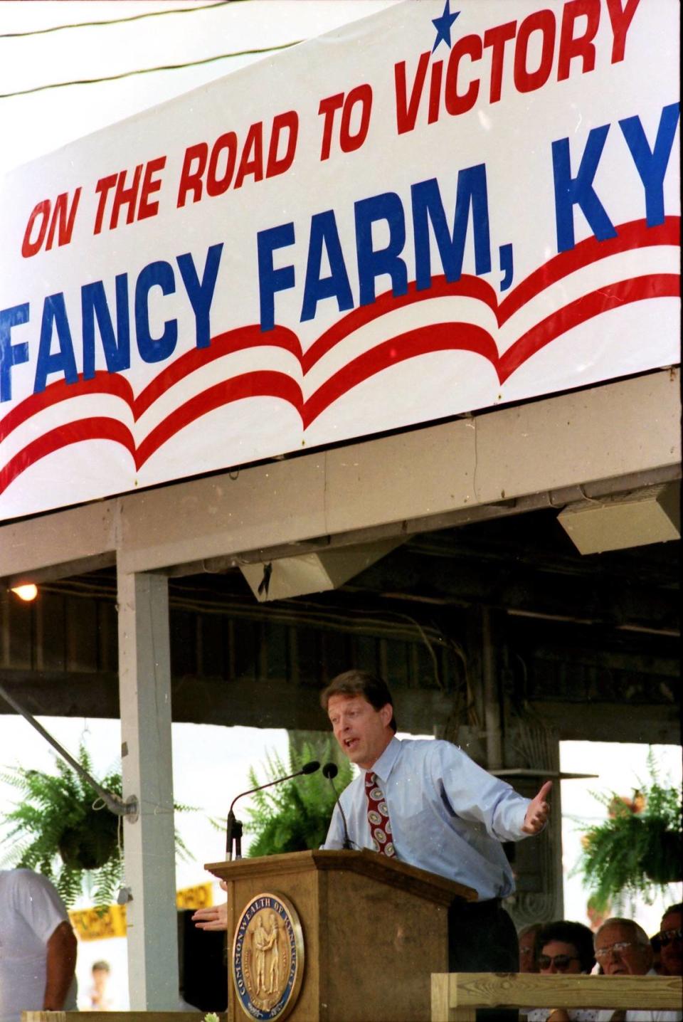 U.S. senator from Tennessee and Democratic vice presidential nominee Al Gore spoke at the annual Fancy Farm political picnic Aug. 1, 1992. Gore arrived by motorcade and made his entrance to the Paul Simon tune “You Can Call Me Al.” He made his way to the stage using double-fisted handshakes with those in the crowd who had pushed their way to the front. The crowd was the largest at a Fancy Farm political picnic in at least the last 10 years. Many of the people, like Judy Chandler of Paducah, came especially to see Gore. Chandler jumped up and down with excitement after Gore hugged her during his exit. “I got to kiss him,” Chandler said. “He’s good looking.” Republican U.S. Sen. Mitch McConnell, who followed Gore to the platform, said that “It’s important to realize that not all change is good change.” Photo by Tim Sharp | staff