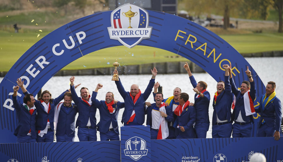 FILE - In this Sept. 30, 2018, file photo, Europe team captain Thomas Bjorn, center, holds the trophy as he celebrates with his team after Europe won the Ryder Cup on the final day of the 42nd Ryder Cup at Le Golf National in Saint-Quentin-en-Yvelines, outside Paris, France. The pandemic-delayed 2020 Ryder Cup returns the United States next week at Whistling Straits along the Wisconsin shores of Lake Michigan. (AP Photo/Francois Mori, File)