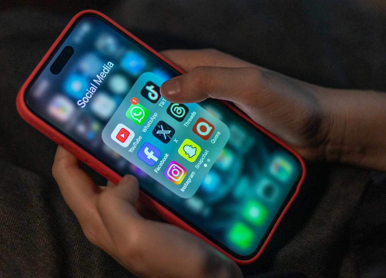 BATH, UNITED KINGDOM - DECEMBER 19: A 12-year-old boy looks at an iPhone screen showing various social media apps including TikTok, Facebook and X, on December 19, 2023 in Bath, England. The amount of time children spend on screens each day rocketed during the Covid pandemic by more than 50 per cent, the equivalent of an extra hour and twenty minutes. Researchers say that unmoderated screen time can have long-lasting effects on a child's mental and physical health. Recently TikTok announced that every account belonging to a user below age 18 have a 60-minute daily screen time limit automatically set. (Photo by Matt Cardy/Getty Images)