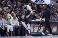 Dallas Mavericks' Luka Doncic slowly walks off the court with a staff member during the first half of Game 2 of the team's NBA basketball first-round playoff series against the Los Angeles Clippers in Dallas, Friday, April 26, 2024. Doncic continued playing in the half. (AP Photo/Tony Gutierrez)