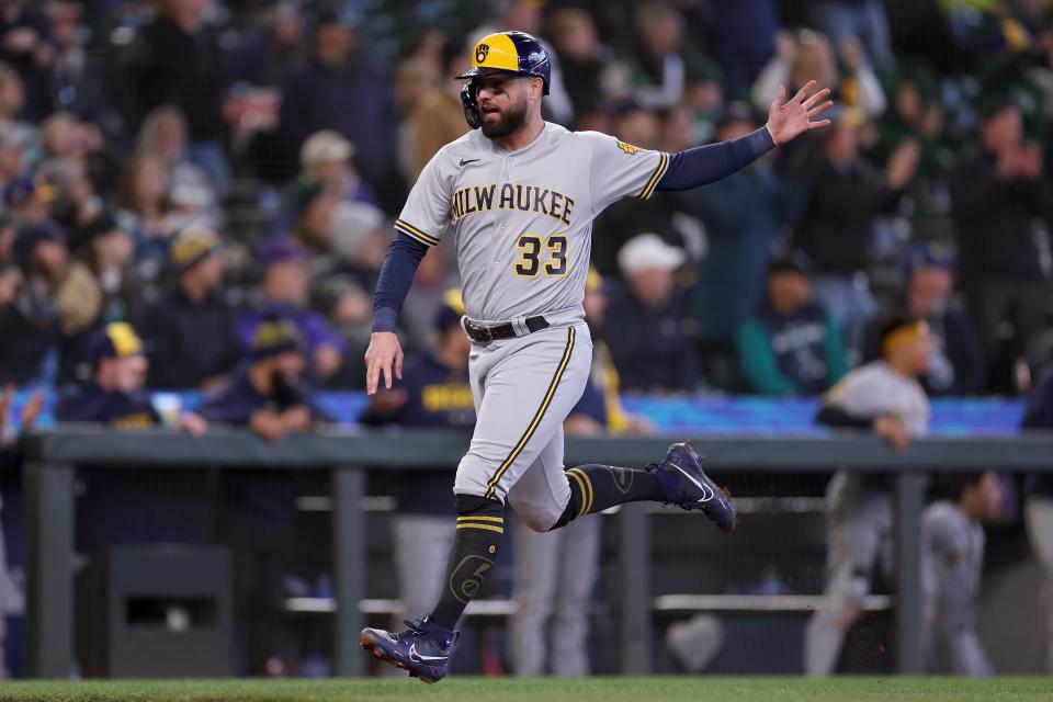 Jesse Winker scores for the Brewers in the seventh inning Wednesday in Seattle.