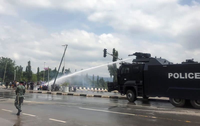 Police use water cannons to disperse people protesting against alleged brutality by SARS members in Abuja