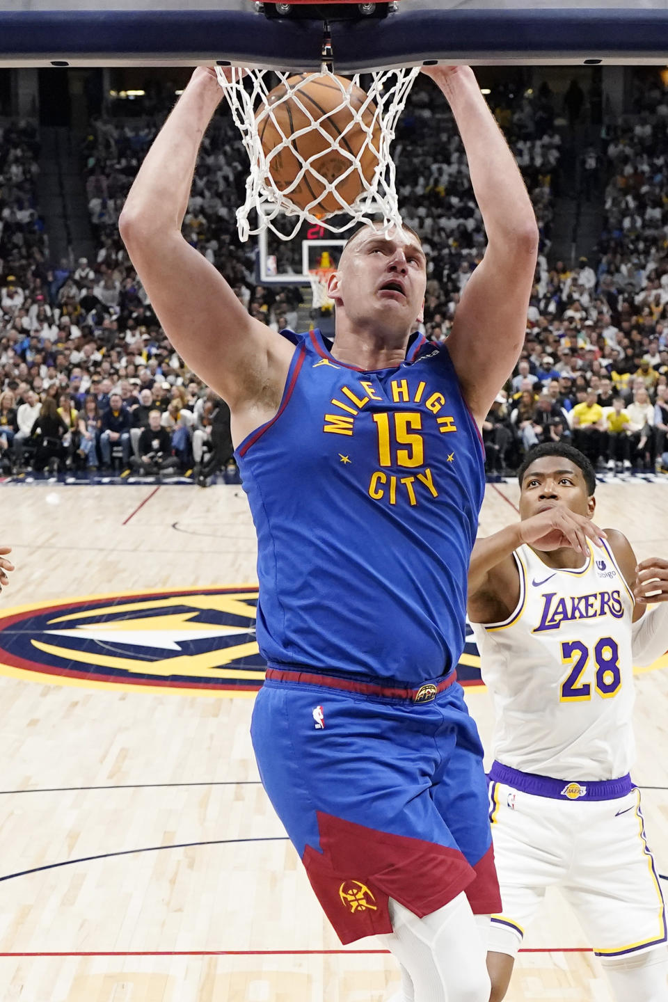 Denver Nuggets center Nikola Jokic (15) dunks against the Los Angeles Lakers during the first half in Game 1 of an NBA basketball first-round playoff series, Saturday, April 20, 2024, in Denver. (AP Photo/Jack Dempsey)