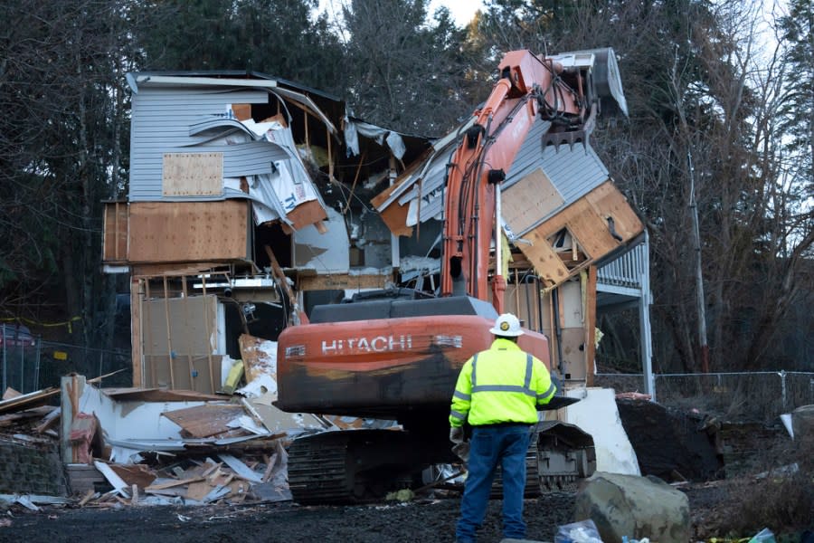 Heavy equipment is used to demolish the house where four University of Idaho students were killed in 2022 on Thursday, Dec. 28, 2023, in Moscow, Idaho. Students Ethan Chapin, Xana Kernodle, Madison Mogen and Kaylee Goncalves were fatally stabbed there in November 2022. (AP Photo/Ted S. Warren)