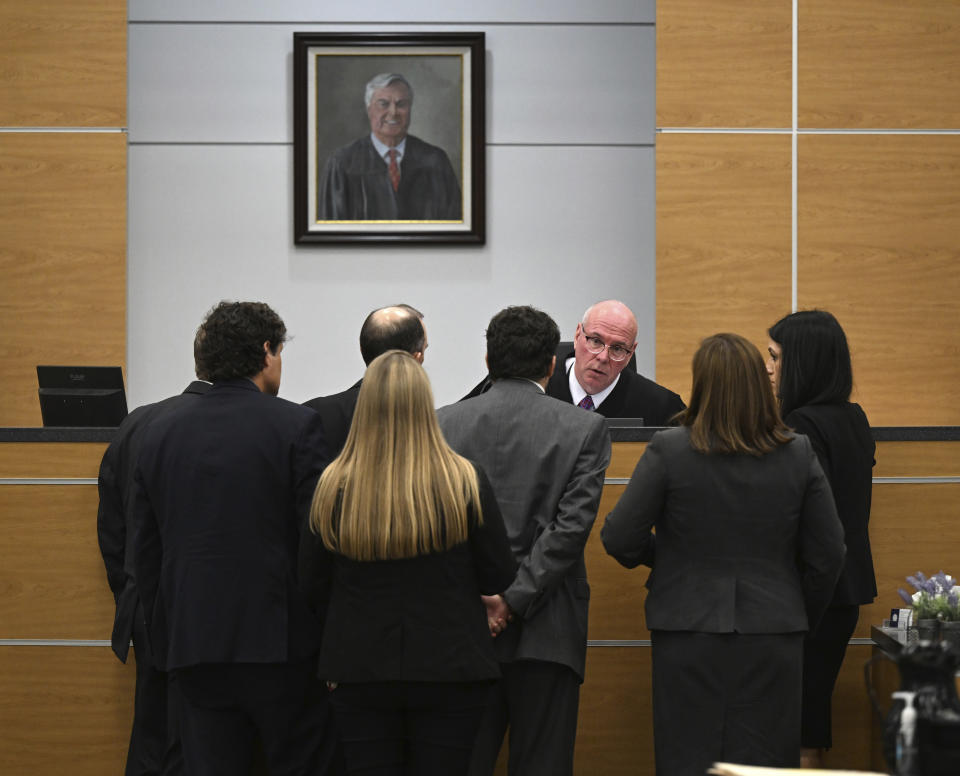 Superior Court Judge David Hall talks with defense and prosecution attorneys during a hearing, Monday, Oct. 30, 2023, for Molly Corbett and her father, Thomas Martens, in the 2015 death of Molly's husband, Jason Corbett at the Davidson County Courthouse in Lexington, N.C. (Walt Unks/The Winston-Salem Journal via AP, Pool)