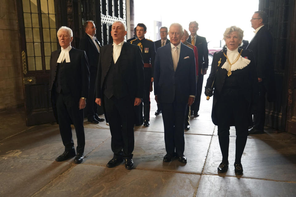 From left, Speaker of the House of Lords, Lord McFall, Speaker of the House of Commons, Sir Lindsay Hoyle, Britain's King Charles III, and Black Rod, Sarah Clarke line up, during a visit to Westminster Hall at the Palace of Westminster to attend a reception ahead of the coronation, in London, Tuesday May 2, 2023. (Arthur Edwards/Pool Photo via AP)