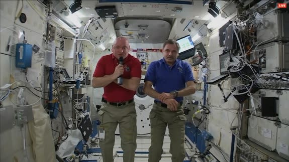 One-year space station crewmembers Scott Kelly (left) and Mikhail Kornienko (right) talk to reporters on April 28, 2015.