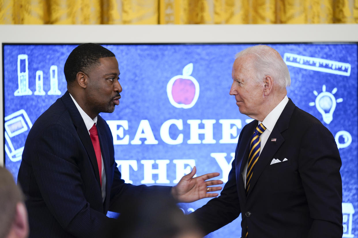 President Joe Biden shakes hands with 2022 National Teacher of the Year Kurt Russell during the 2022 National and State Teachers of the Year event in the East Room of the White House in Washington, Wednesday, April 27, 2022. (AP Photo/Susan Walsh)