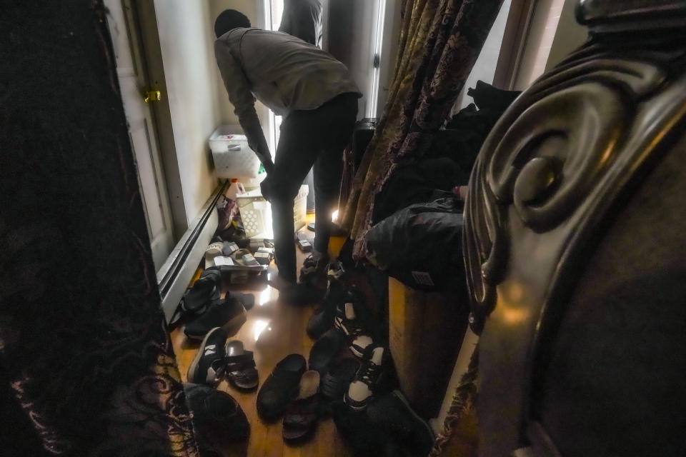 A migrant from Senegal searches through a delivery of city identification cards approved for African migrants at Bronx's Masjid Ansaru-Deen mosque, Friday March 15, 2024, in New York. The mosque, formerly the family home for its Imam Omar Niass, has served as a shelter for African migrants since 2020, providing a physical address where mail can be received, while they seek asylum in the United States, (AP Photo/Bebeto Matthews)