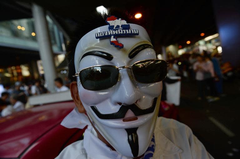 A Thai opposition protester wears a mask during a rally against an amnesty bill called by businessmen in Bangkok's financial district of Silom on November 4, 2013