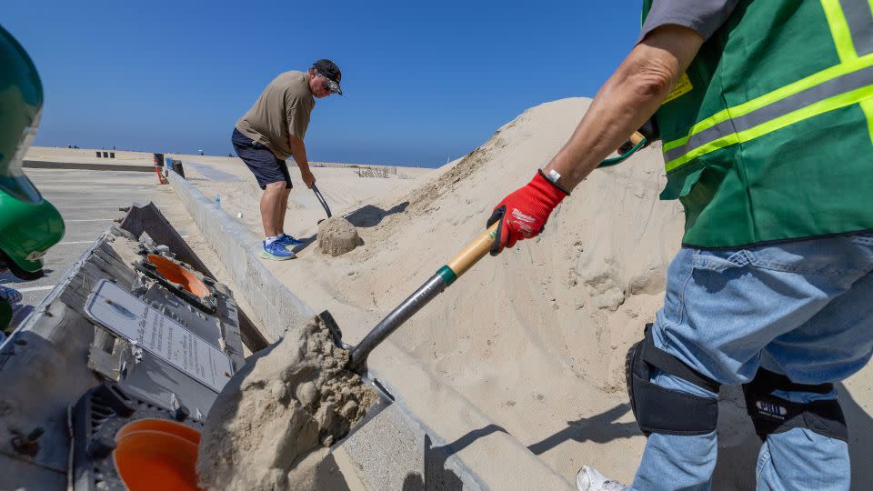 Volunteers from the West Orange County Community Emergency Response Team load sandbags for local residents as the hurricane approaches. - Allen J. Schaben/Los Angeles Times/Getty Images