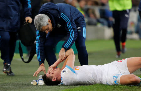 Soccer Football - Ligue 1 - Olympique de Marseille vs Bordeaux - Orange Velodrome, Marseille, France - February 18, 2018 Marseille's Florian Thauvin receives medical attention after sustaining an injury REUTERS/Jean-Paul Pelissier