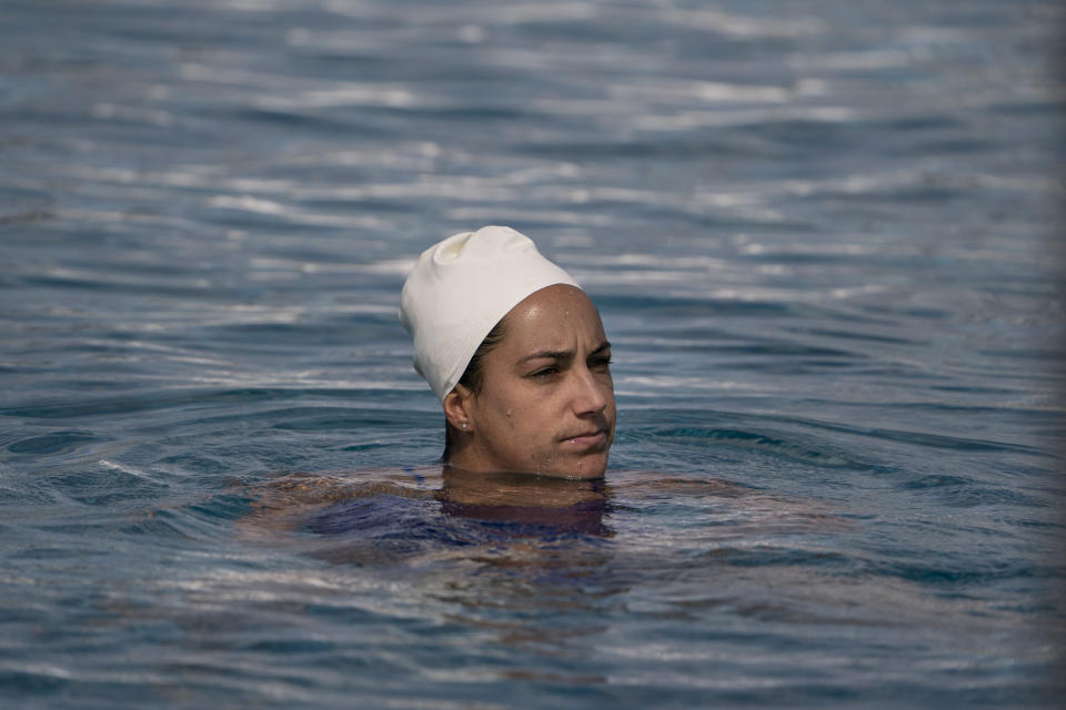 Maggie Steffens, a member of the U.S. women's water polo team, pauses for a moment while training at MWR Aquatic Training Center Tuesday, April 27, 2021, in Los Alamitos, Calif. Steffens is going for a third consecutive gold medal with the U.S. women's water polo team at the Tokyo Olympics this summer. Steffens became team captain in 2014, and that role maybe took on some added significance while the U.S. served as its own opponent for 15 months before it swept a three-game series against Canada in May. (AP Photo/Jae C. Hong)