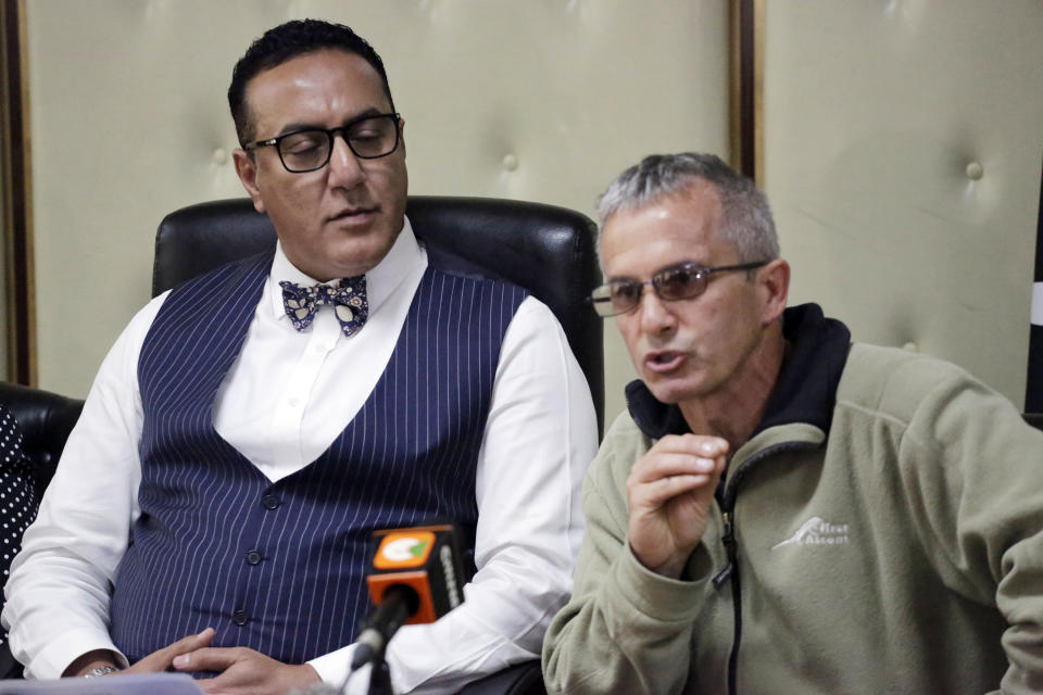 Kenya's Cabinet Secretary for Tourism Najib Balala, left, listens to South African wildlife veterinary David Zimmerman during a press conference on an investigation on the deaths of several black rhinos, in Nairobi, Kenya, Thursday, July 26, 2018. At least 8 black rhinos died in July after they were relocated by KWS (Kenya Wildlife Services) to Tsavo East national park from Nairobi and Nakuru national parks for repopulation purposes. (AP Photo/Khalil Senosi)