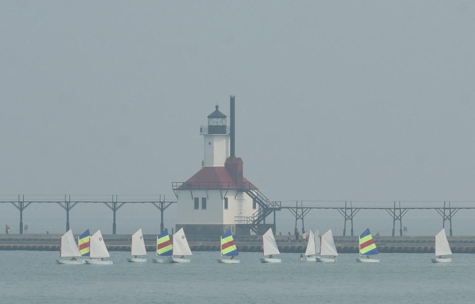 A haze lingers over the St. Joseph Lighthouse and Lake Michigan Wednesday, June 28, 2023, in St. Joseph, Mich., as wildfires continue to burn in Canada.