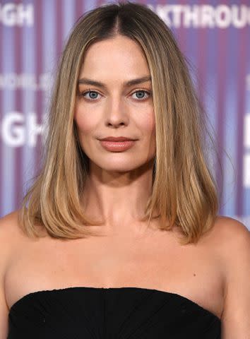<p>Steve Granitz/FilmMagic</p> Margot Robbie attends the 2024 Breakthrough Prize ceremony with dramatic haircut