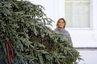 First lady Melania Trump looks at the 2020 Official White House Christmas tree as it is presented on the North Portico of the White House, Monday, Nov. 23, 2020, in Washington. (AP Photo/Andrew Harnik)