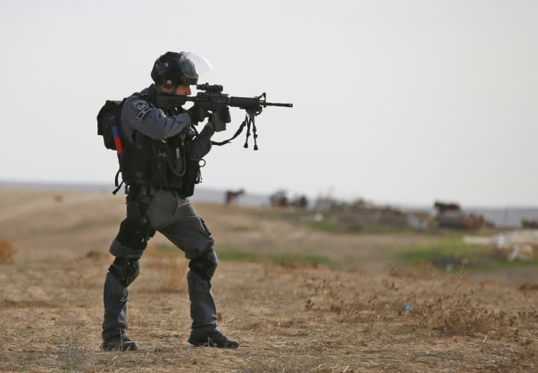 Israeli policeman takes aim in the Bedouin village of Umm al-Heiran, in the Negev desert, where police say they shot dead an Arab-Israeli in a car-ramming attack