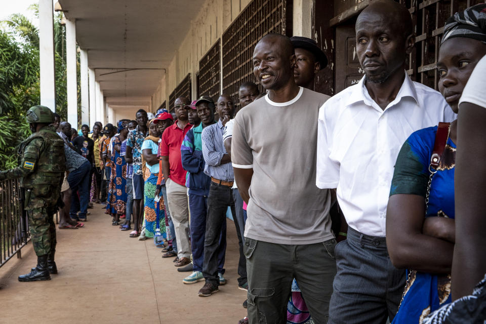 People queue to cast their votes for presidential and legislative elections, at the Lycee Boganda polling station in the capital Bangui, Central African Republic, Sunday, Dec. 27, 2020. President Faustin-Archange Touadera and his party said the vote will go ahead after government forces clashed with rebels in recent days and some opposition candidates pulled out of the race amid growing insecurity. (AP Photo)