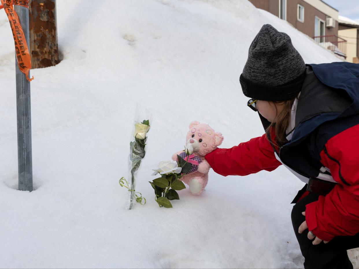 A young child pays tribute to the victims of the Laval daycare crash in February 2023 (Evan Buhler/REUTERS)