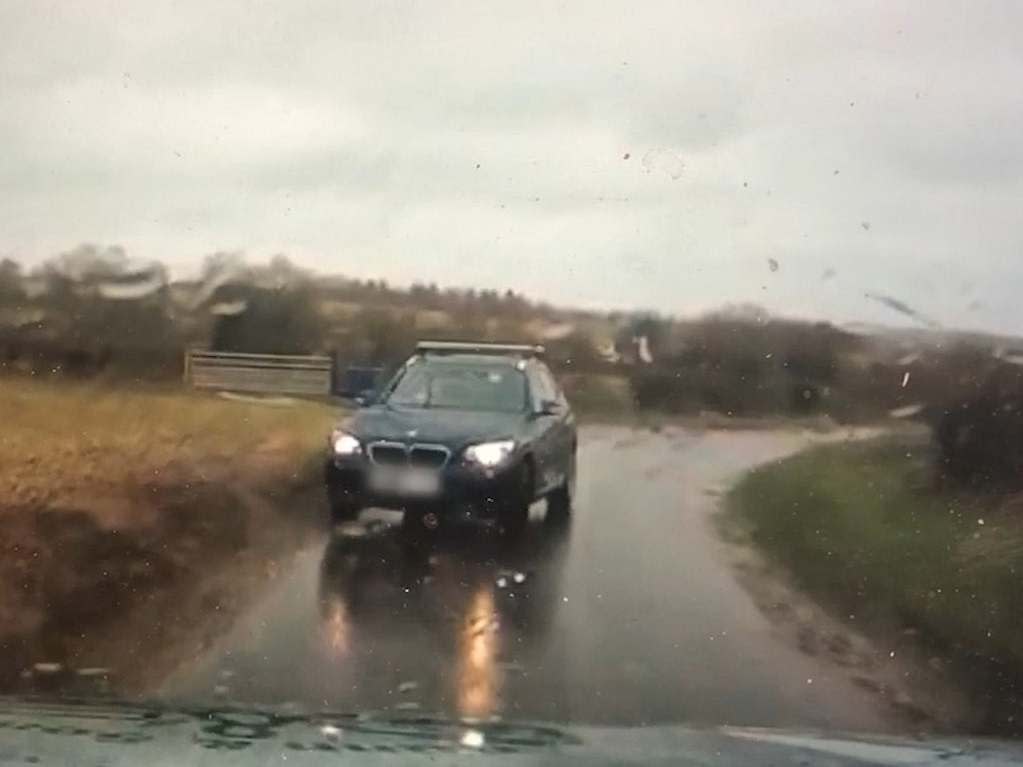 A still from dashcam footage of a blue BMW on the wrong side of the road near RAF Croughton: PA