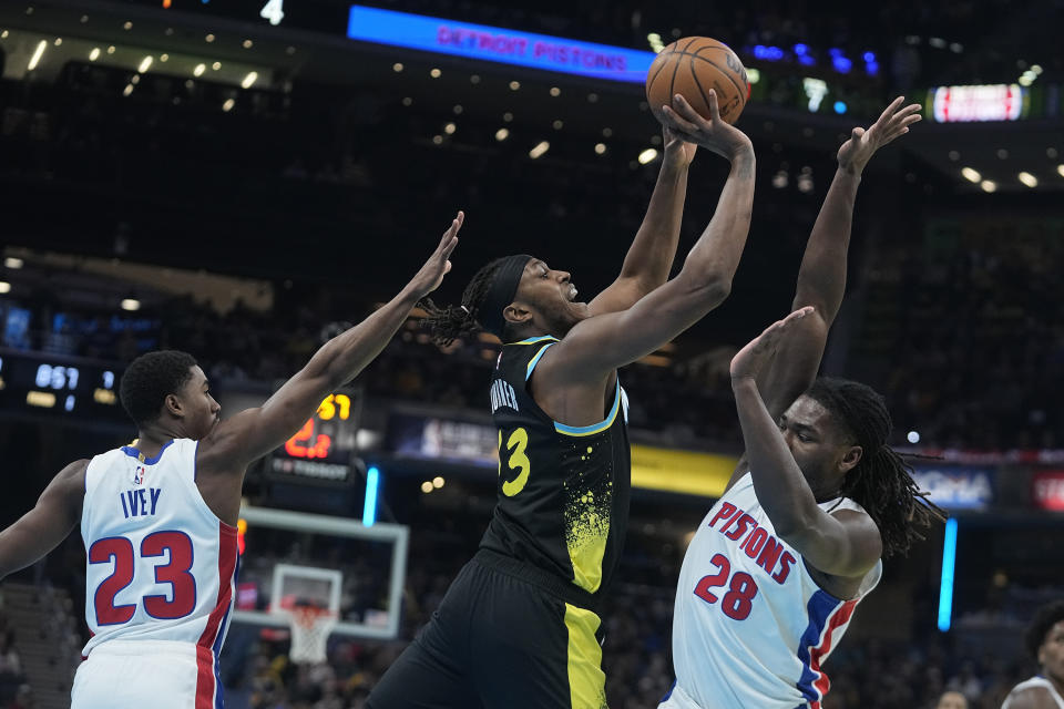 Indiana Pacers' Myles Turner, center, shoots against Detroit Pistons' Jaden Ivey (23) and Isaiah Stewart (28) during the first half of an NBA basketball In-Season Tournament game Friday, Nov. 24, 2023, in Indianapolis. (AP Photo/Darron Cummings)