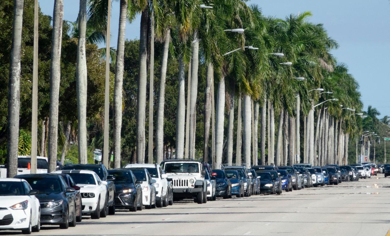 Cars line up to get into Gaines Park for drive-thru coronavirus testing in West Palm Beach, Fla.,  Dec. 26. Testing is free, but people should bring their insurance or Medicare/Medicaid card.