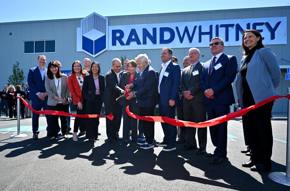 The Rand-Whitney ribbon-cutting ceremony for a 384,000 square-foot warehouse Thursday in Boylston with Robert and Jonathan Kraft and Gov. Maura Healey.