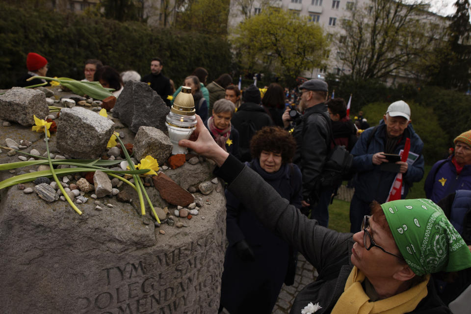 During personal unofficial observances marking the 80th anniversary of the Warsaw Ghetto Uprising a woman places a candle in Warsaw, Poland, Wednesday, April 19, 2023 on top of the memorial of the bunker where the leader of the doomed uprising, Mordechaj Anielewicz, and his comrades committed mass suicide. (AP Photo/Michal Dyjuk)