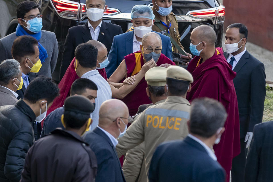 An attendant monk adjusts the face mask on Tibetan spiritual leader the Dalai Lama as he arrives at the Zonal Hospital to receive a COVID-19 vaccine in Dharmsala, India, Saturday, March 6, 2021. Medical officers confirmed that the Tibetan leader got the Covishield vaccine and is not showing any adverse reaction to the vaccine. (AP Photo/Ashwini Bhatia)