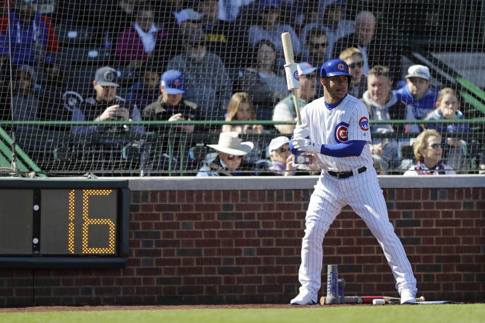 A pitch clock is seen as Chicago Cubs' Willson Contreras waits on deck during the first inning of a spring training baseball game against the Milwaukee Brewers, Saturday, Feb. 23, 2019, in Mesa, Ariz. (AP Photo/Darron Cummings)