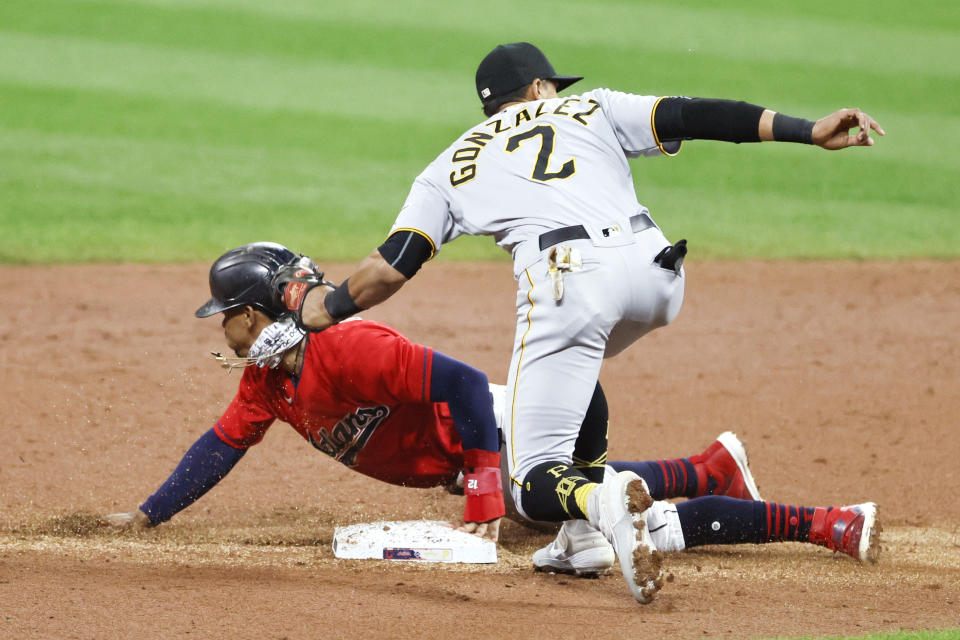 Cleveland Indians' Francisco Lindor, left, steals second base as Pittsburgh Pirates' Erik Gonzalez (2) covers during the third inning of a baseball game, Friday, Sept. 25, 2020, in Cleveland. (AP Photo/Ron Schwane)