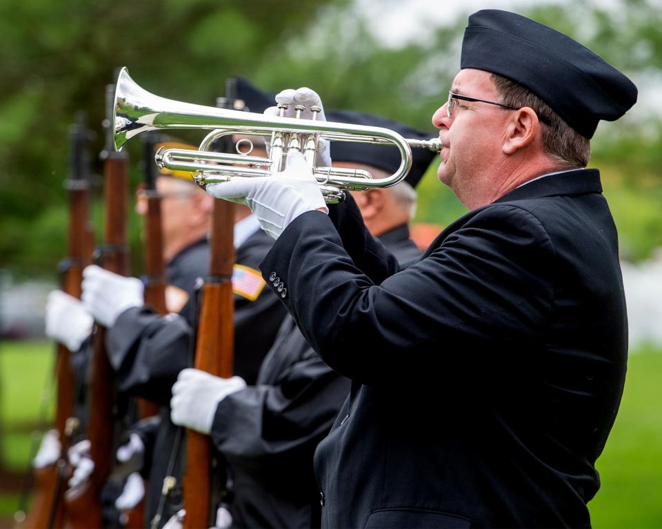 Playing taps is Dave Farren, of Bensalem, a member of the Guardians of the National Cemetery, during the service for four unclaimed veterans, and one spouse, held at the Washington Crossing Veterans Cemetery in Upper Makefield, on Thursday, April 27, 2023.