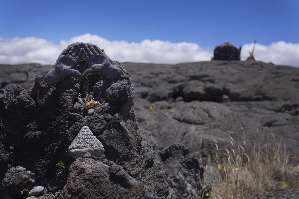 A symbol of support and solidarity for those who blocked construction of a new telescope on Mauna Kea rests on a lava rock below a ceremonial platform at the base of Mauna Kea in Hawaii, on Saturday, July 15, 2023. (AP Photo/Jessie Wardarski)