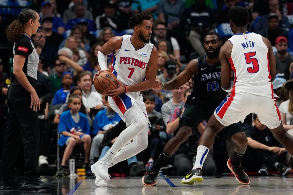 Pistons forward Troy Brown Jr. controls the ball as Mavericks forward Tim Hardaway Jr. defends during the first half on Friday, April 12, 2024, in Dallas.
