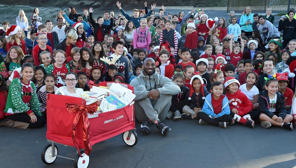 The late star surprised students with a holiday visit at a local school on Dec. 19, 2018, in Mission Viejo, California.