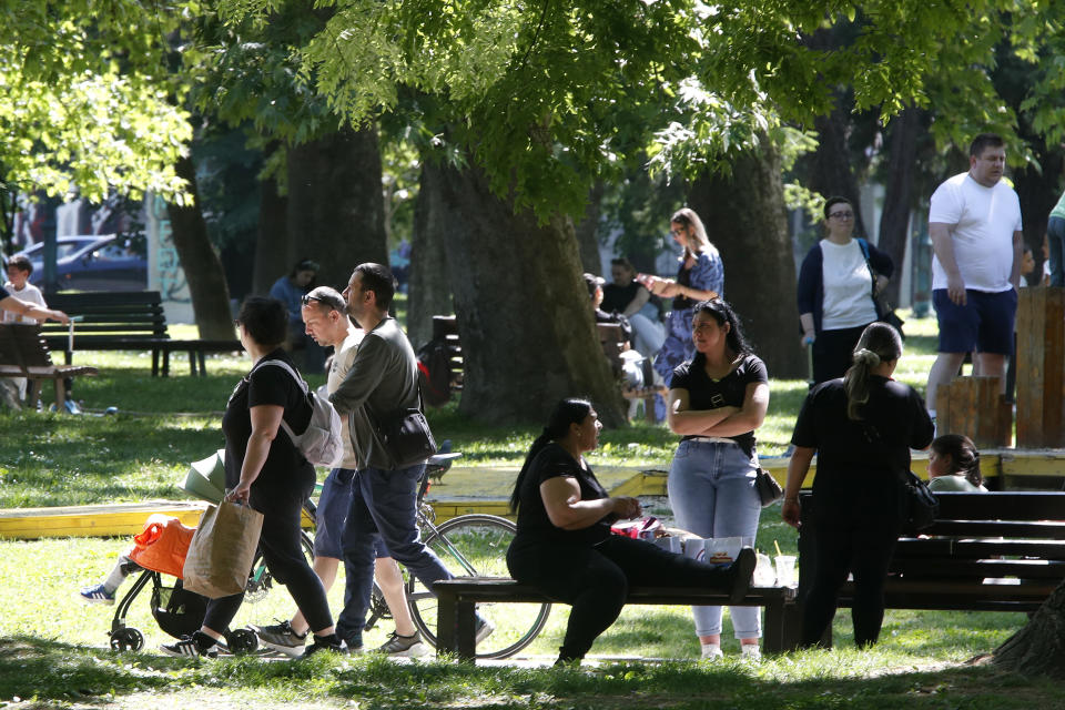 People enjoy the sun in a park in Skopje, North Macedonia, on Monday, May 6, 2024. Voters go to the polls on Wednesday in North Macedonia to cast ballots for parliamentary election and presidential runoff, for the second time in two weeks. (AP Photo/Boris Grdanoski)