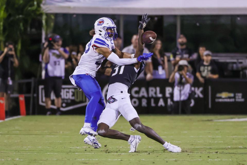 Oct 5, 2022; Orlando, Florida, USA; UCF Knights cornerback Brandon Adams (31) blocks a pass intended for Southern Methodist Mustangs wide receiver Austin Upshaw (23) during the second half at FBC Mortgage Stadium. Mandatory Credit: Mike Watters-USA TODAY Sports